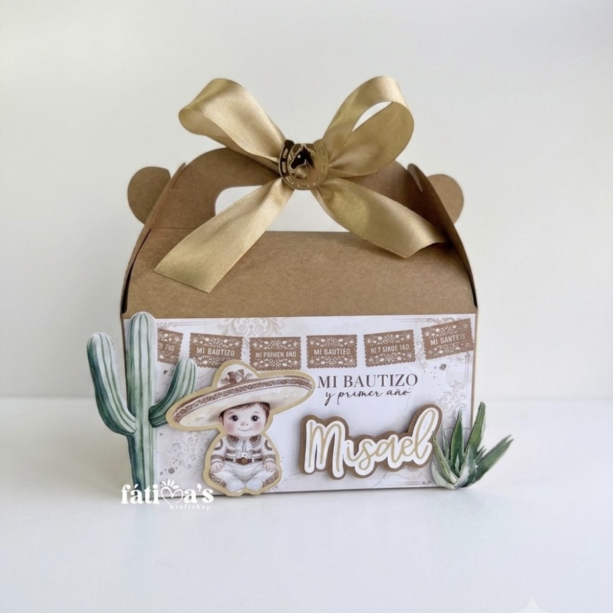Personalized Charro theme baptism and first birthday kraft favor box for Misael featuring a gold bow and cactus cutouts.
